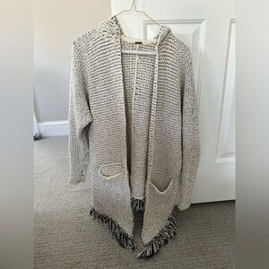 Free People sweater with pockets, hood, and tassel detail